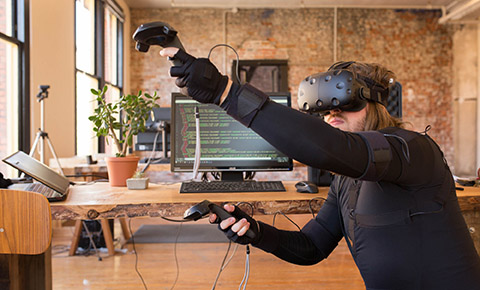 Using a virtual reality HMD and handheld controllers with full-body motion capture